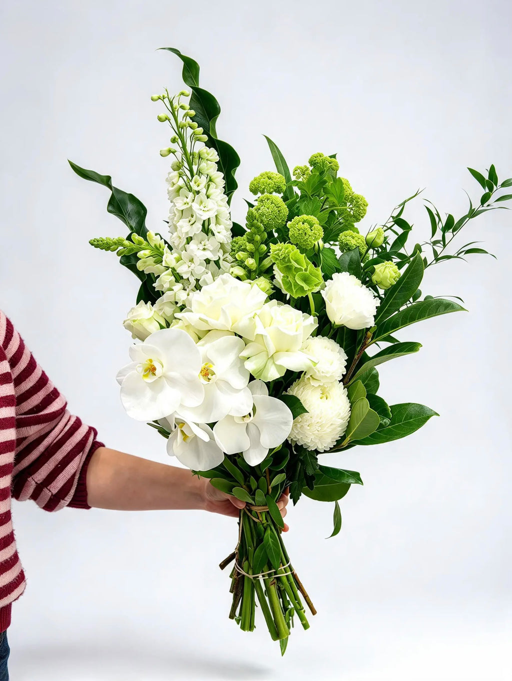 White Phalaenopsis orchid and rose hand-tied bouquet with seasonal white flowers and green foliage by Quiet Bloom florist Richmond Melbourne.